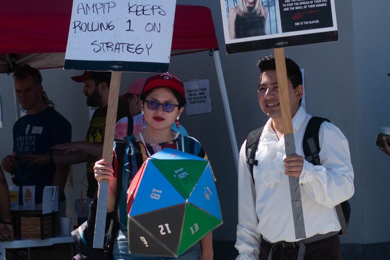 A writer wears a costume that looks like a 20 sided die used in Dungeons & Dragons games.