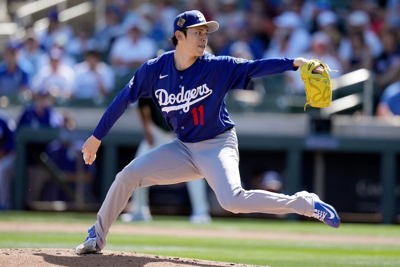 Photo of a baseball player throwing a pitch at a game.