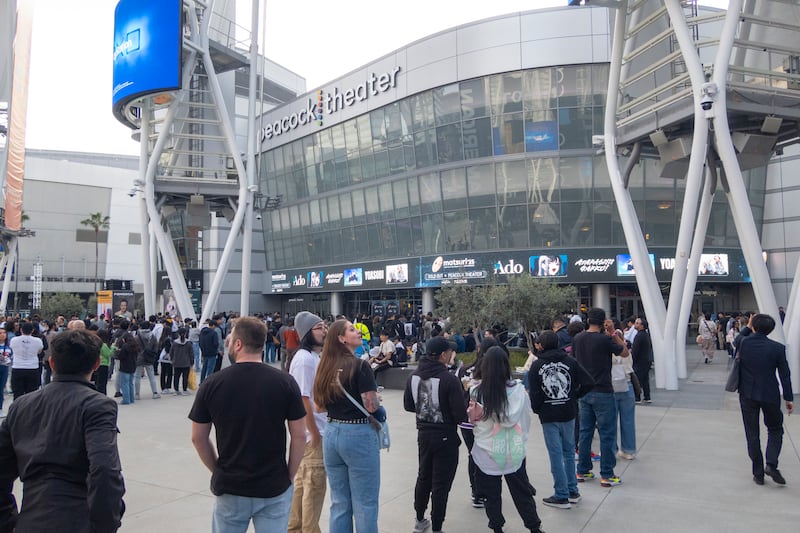 Photo of crowd of people lining up in front of a concert venue