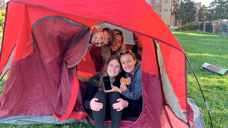 A photo of students inside of a tent they built.