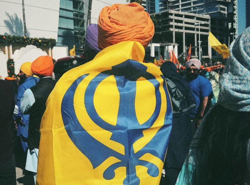 DESCRIBE THE IMAGE FOR ACCESSIBILITY, EXAMPLE: Photo of a chef putting red sauce onto an omelette.