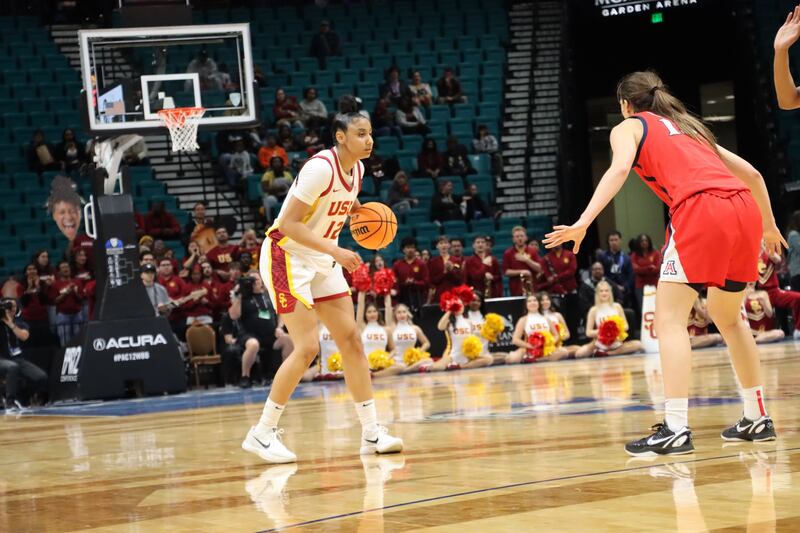 Watkins dribbles the ball beyond the arc with a defender nearby.