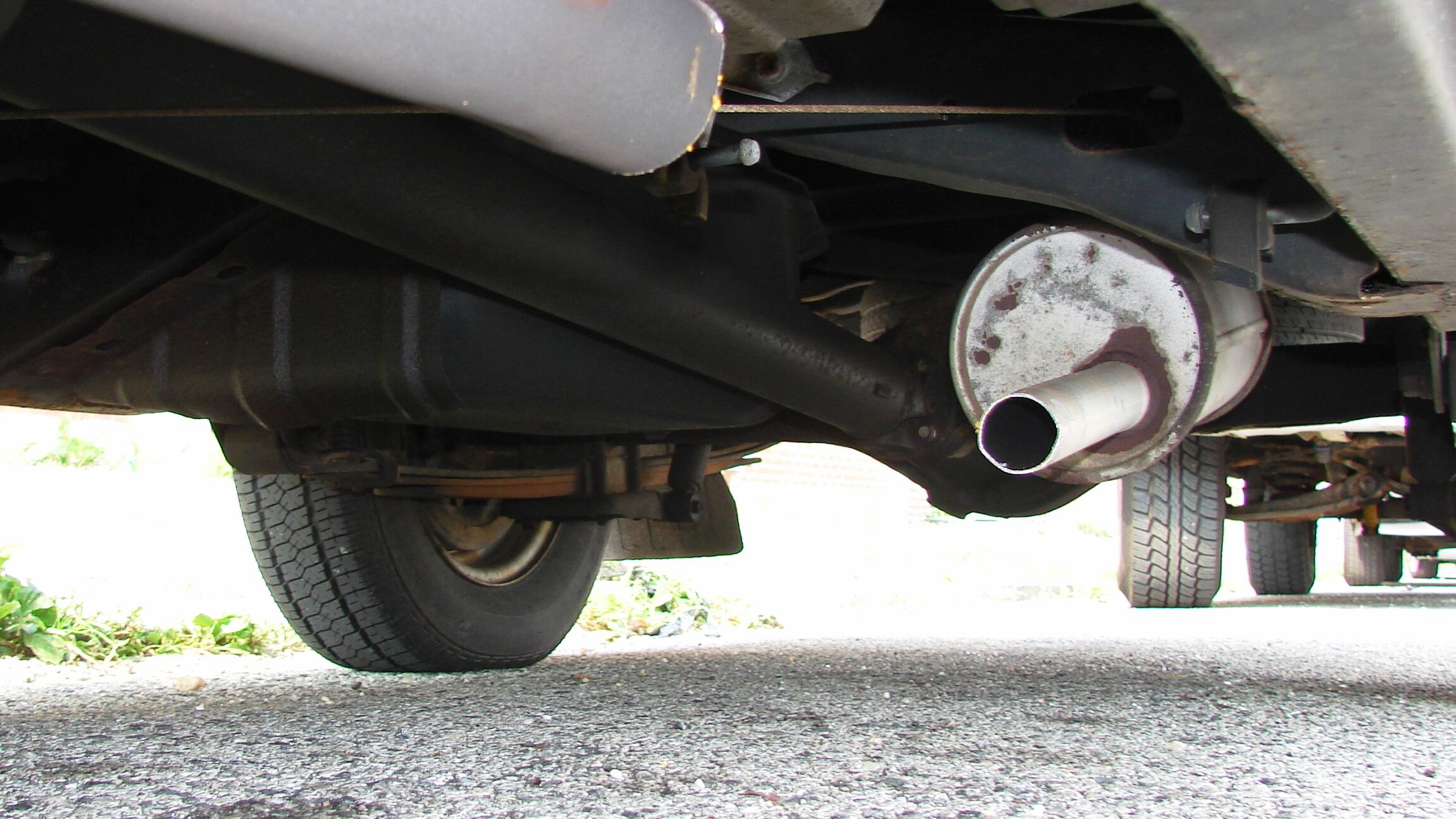 Photo of the bottom of a car showing the catalytic converter.