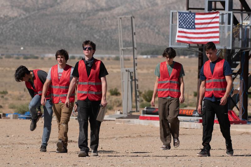 The red team is a minimized team during the final minutes leading up to firing the motor, working on the finishing touches and making the motor ready for the test. Members of the red team walk toward the bunker to conduct the static fire.