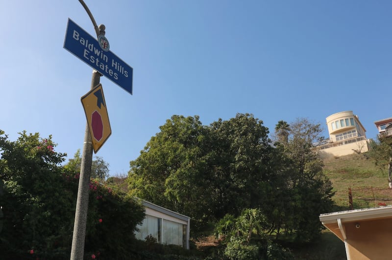 A sign that reads "Baldwin Hills Estates" marks the separation between the homes on the top of the hill from the town homes and apartment complexes that are known as Baldwin Village or "The Jungles."