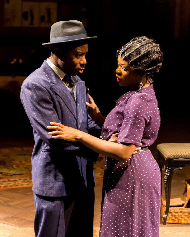 Dennis Pearson holds onto Nija Okoro who is struggling to understand him. She looks away.