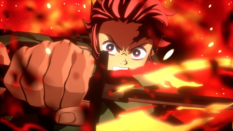 [Tanjiro performs a fiery attack in the new "Demon Slayer" video game.]