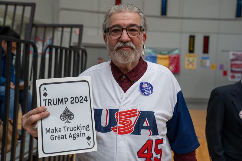 A truck driver with a homemade graphic focusing on making "Trucking Great Again".