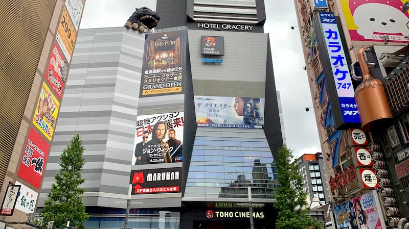 Photo of a large theater with godzilla head popping out