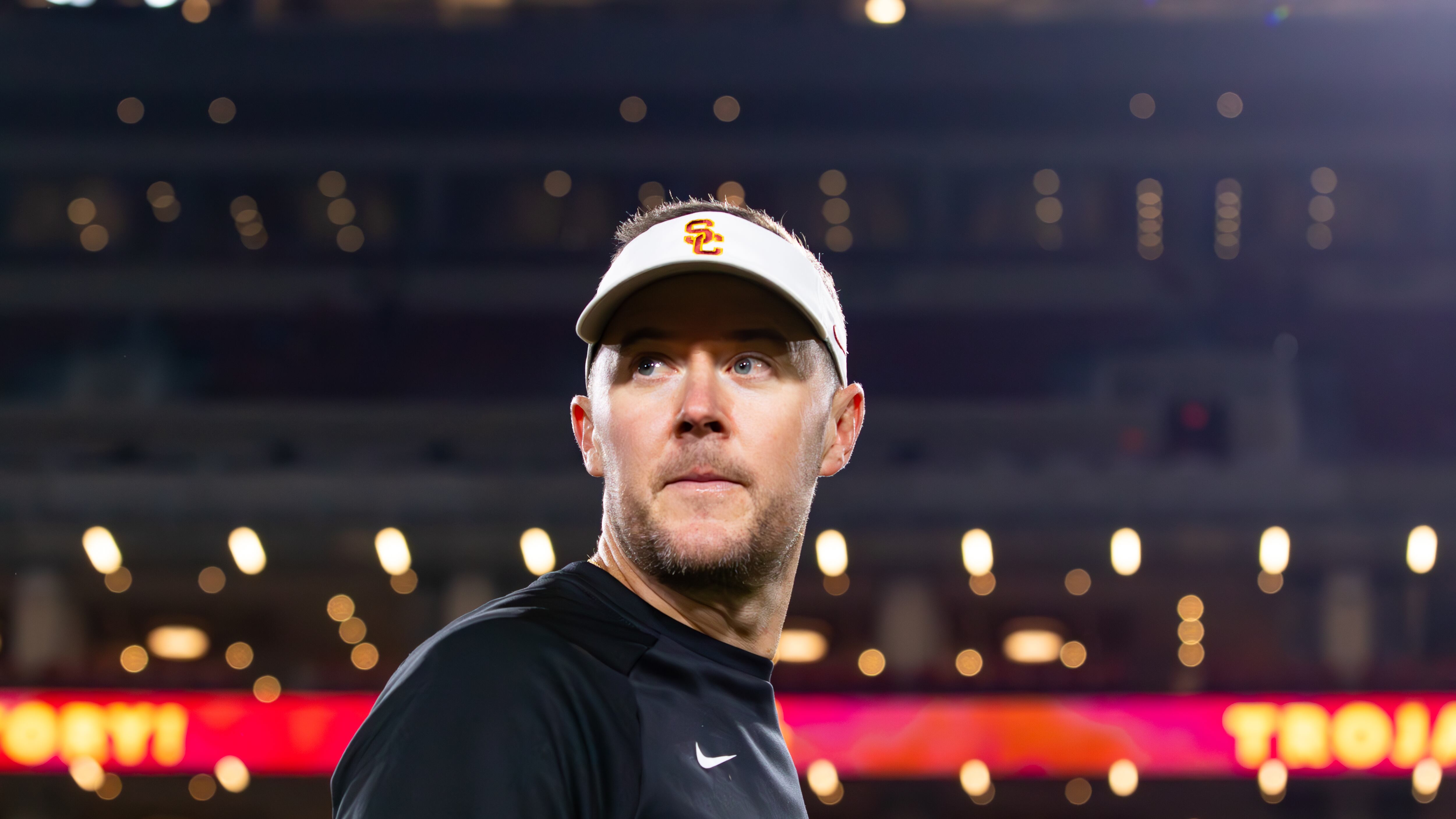 Photo of Lincoln Riley looking to the left, over his shoulder