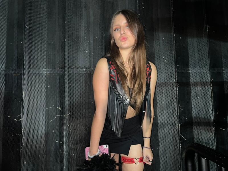 A photo of Wagner posing in a black leather outfit posing and pursing her lips at the concert.