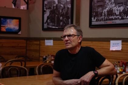 DESCRIBE THE IMAGE FOR ACCESSIBILITY, EXAMPLE: Photo of a chef putting red sauce onto an omelette.
