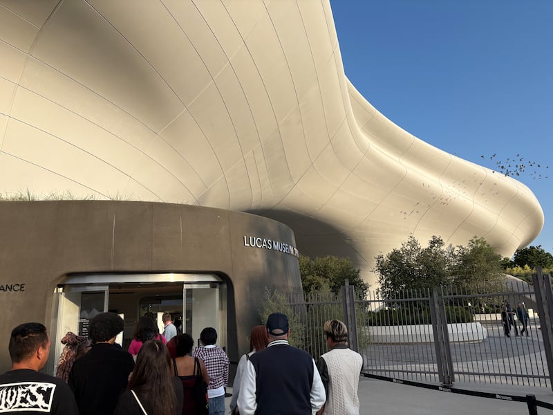 Museum visitors wait in line outside of the security check in.