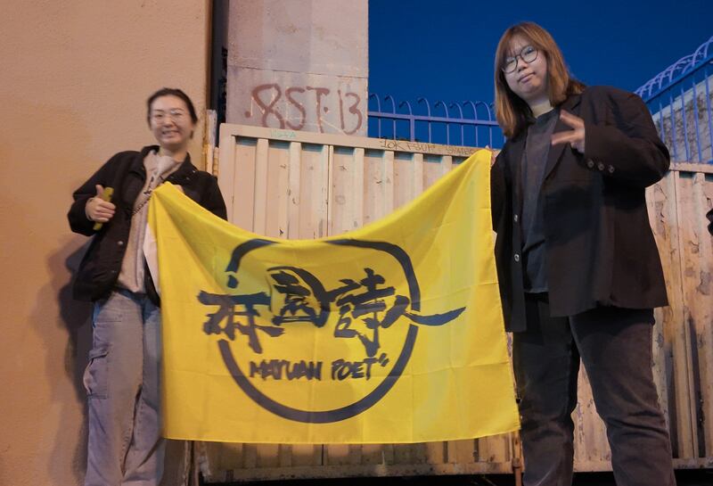 Photo of two women holding a yellow flag