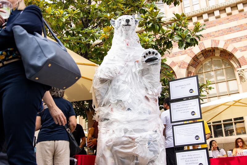 A polar bear made entirely of recycled trash is presented at the Grand Opening of the Sustainability Hub.