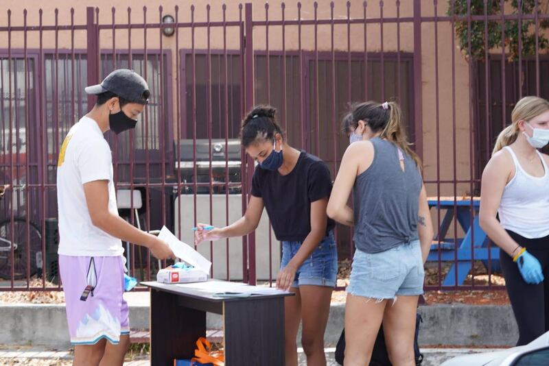 Volunteers registering at a temporary desk set up before starting the process