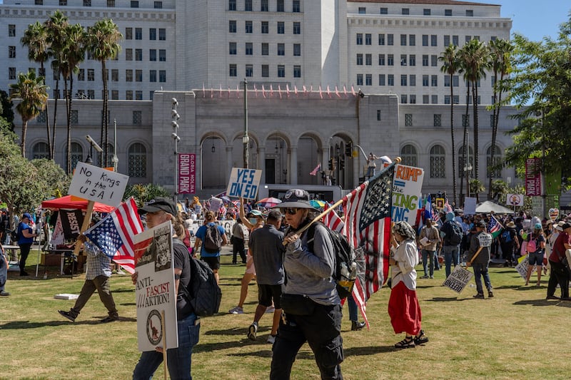 Demonstrators gather in Grand Park at the beginning of the rally.