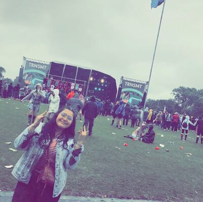 A photo of Acosta with the festival grounds and the stage behind.