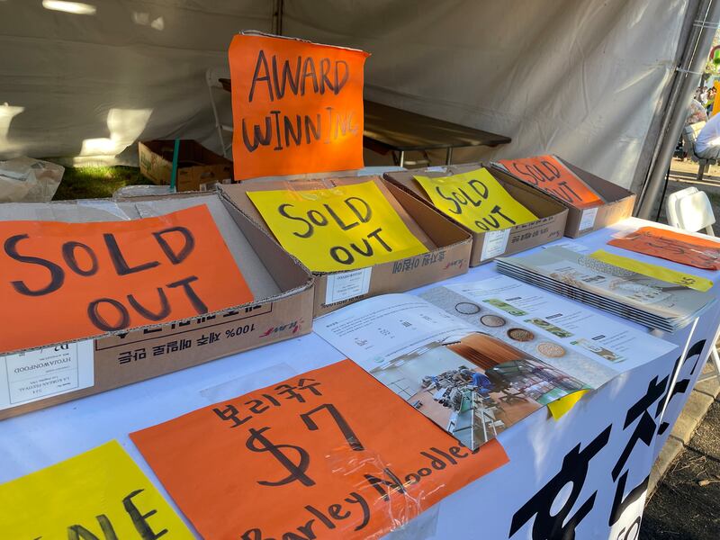 Photo of a booth with orange and yellow sings saying "Sold Out"