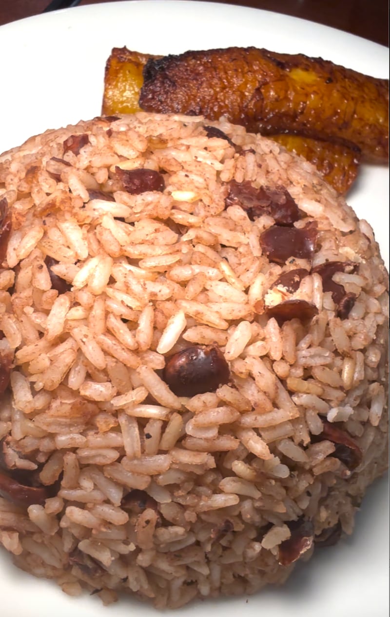 Photo of rice and beans, and plantains on a white plate