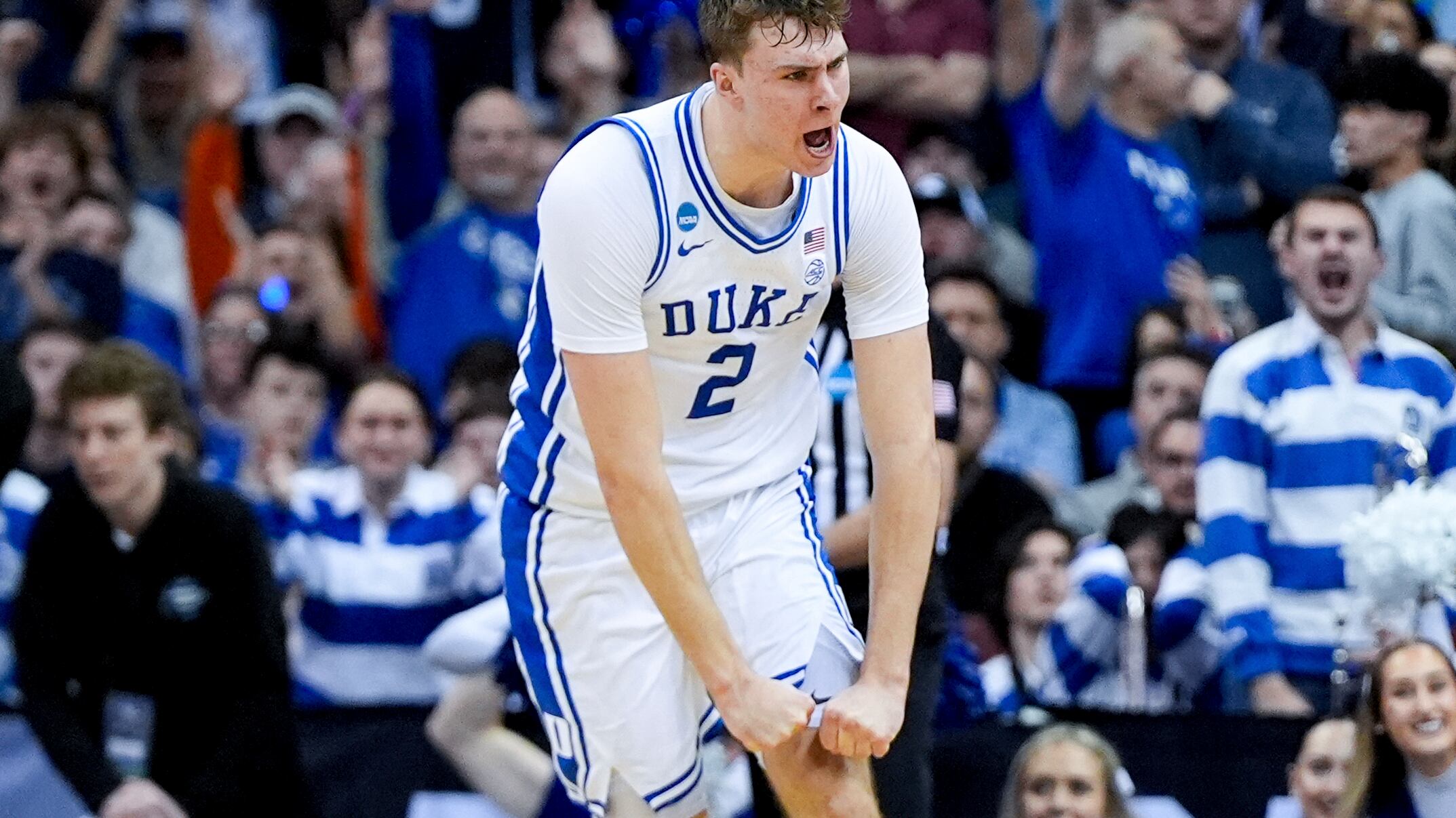 A photo of Cooper Flagg, wearing a white Duke jersey, celebrating.