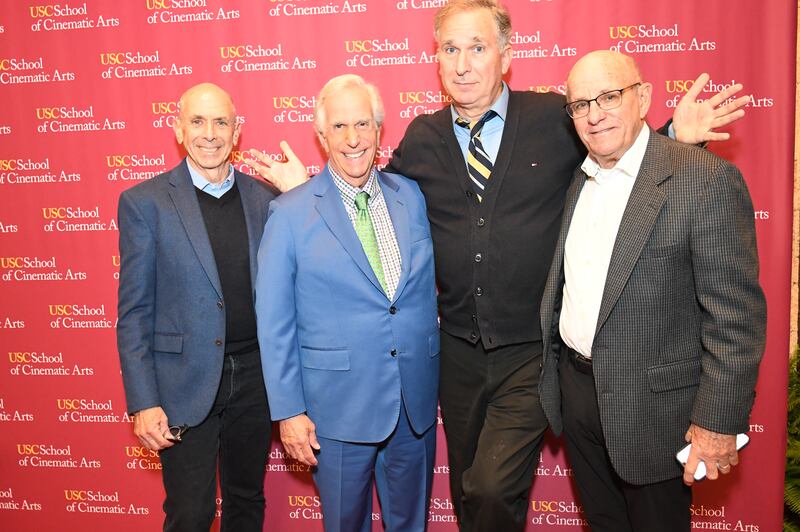 A photo of Barnet Kellman, Henry Winkler, Wayne Federman and David Isaacs in front of a background that says "USC School of Cinematic Arts."