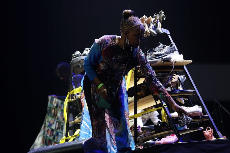 As the lights dim, filmmaker Lawanda Hawkins adds a new pair of shoes to Silent March, her powerful installation honoring children lost to violence.