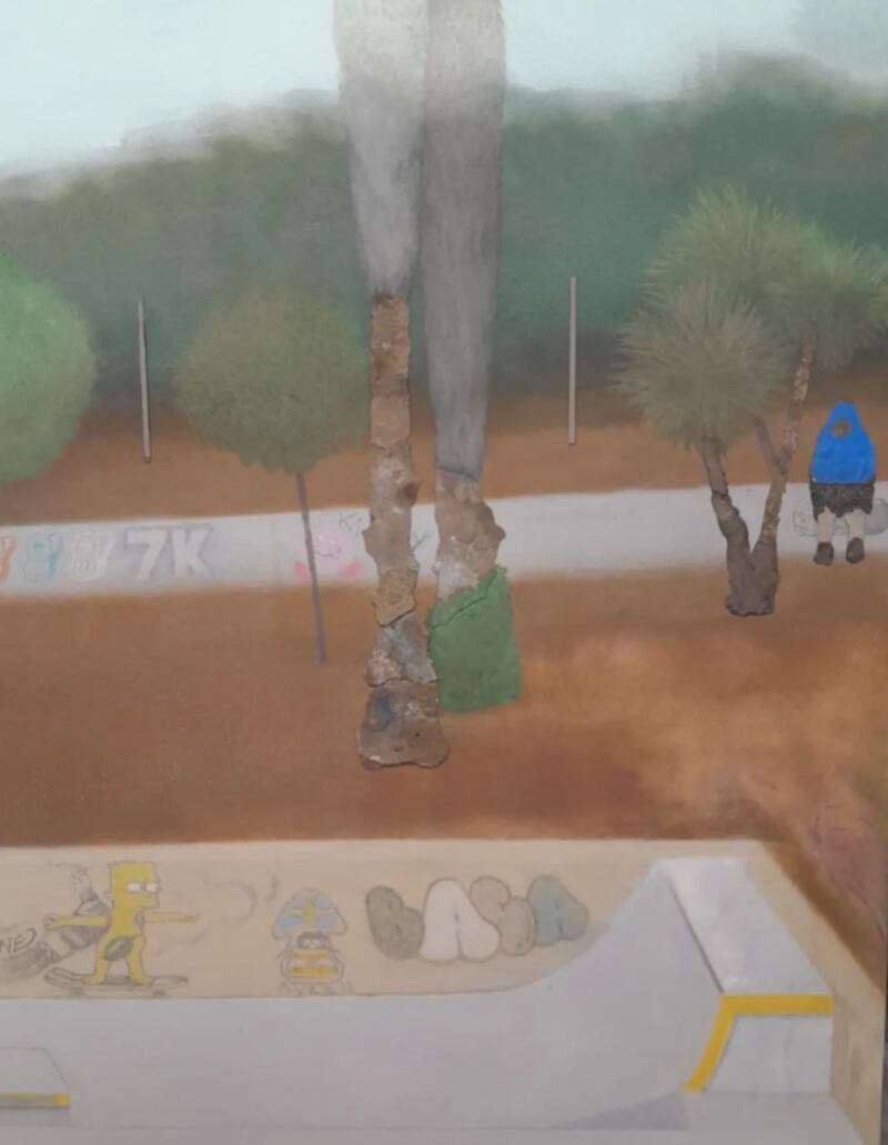 Trees surround a neighborhood skate park.