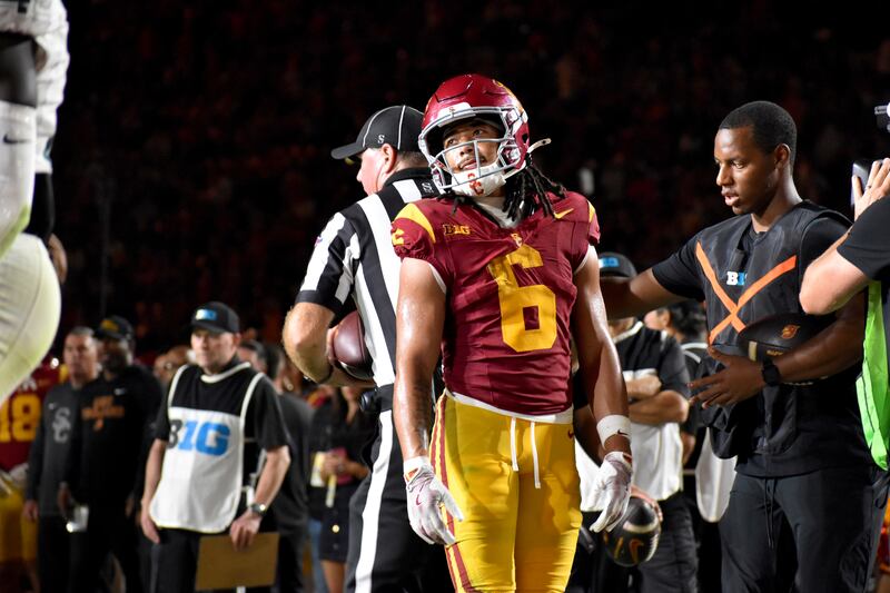 Makai Lemon (6) stands on the sideline in full USC football uniform.