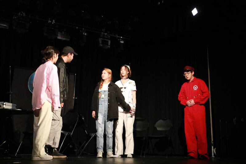 Photo of a group of students acting on stage