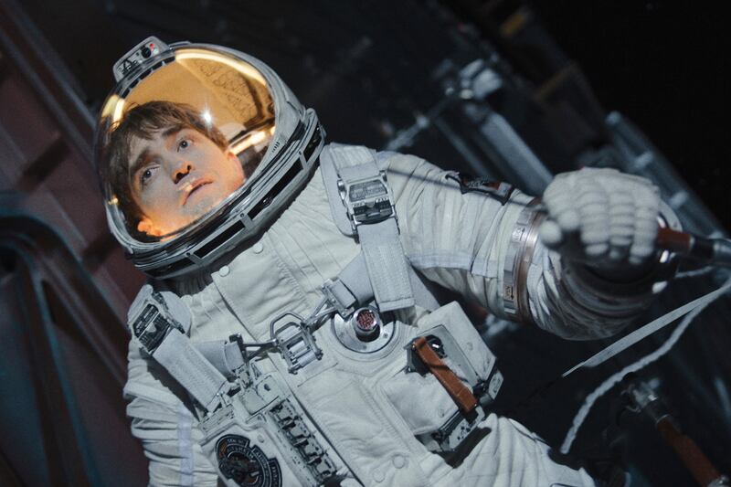 Film still of a man wearing a spacesuit