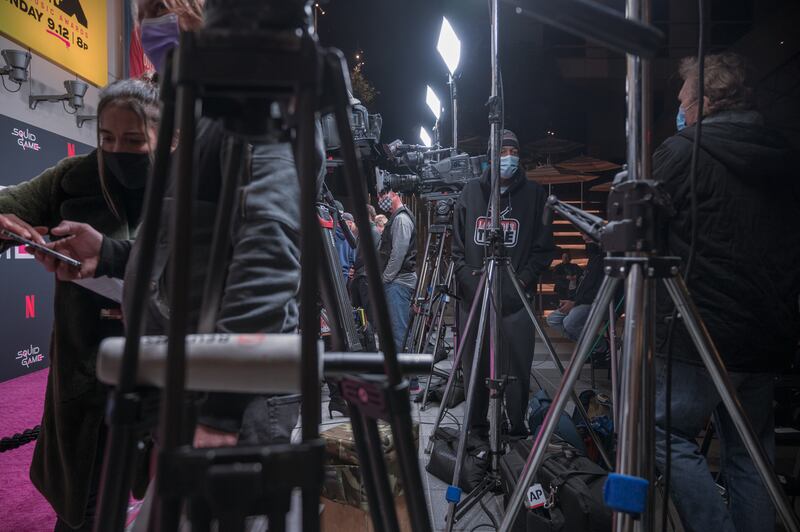 The "Squid Game" Red Carpet flooded by crews of media outlets, lights, and tripods at an event hosted by Netflix at NeueHouse Hollywood on 8 Nov 2021.