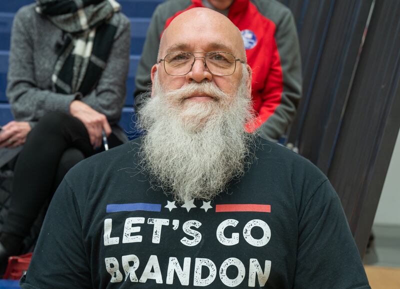 A maintenance worker with a shirt that reads "Let's go Brandon".