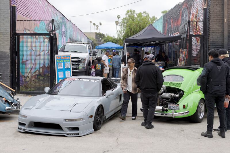 Food stands next to cars