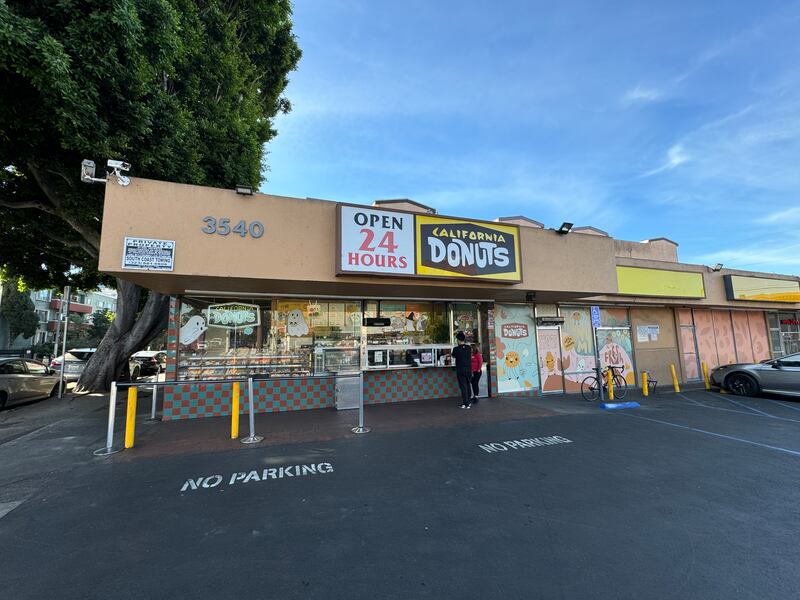 Photo of a building with a sign reading "Open 24 hours" and "California Donuts"