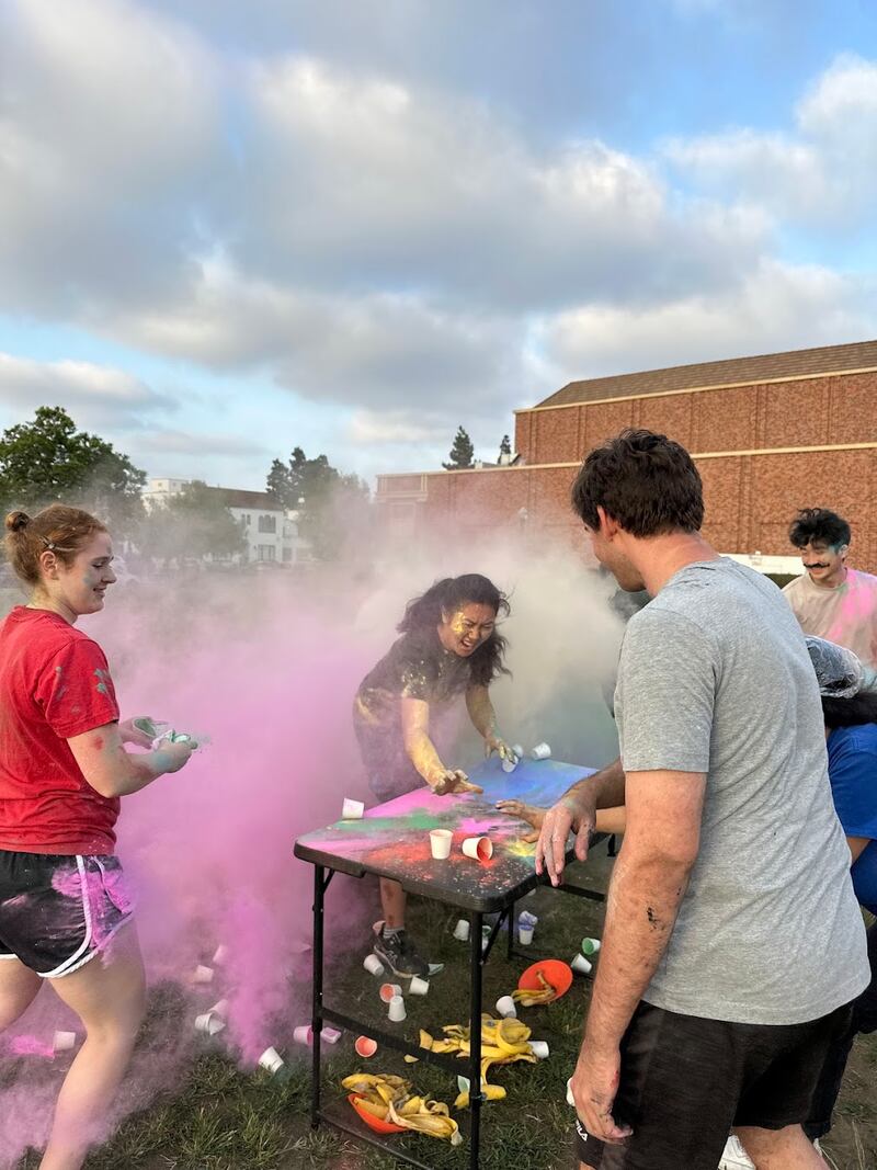 Clouds of pink and white paint explode during an outdoor activity