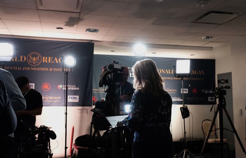 A reporter readies herself to go on TV.