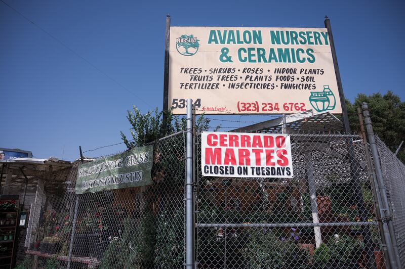 "A photo of the exterior of Avalon Nursery & Ceramics. A sign reads: 'Avalon Nursery & Ceramics: Trees, Shrubs, Roses, Indoor Plants, Fruit Trees, Plants Foods, Soil, Fertilizer, Insecurities, Fungicides.'"