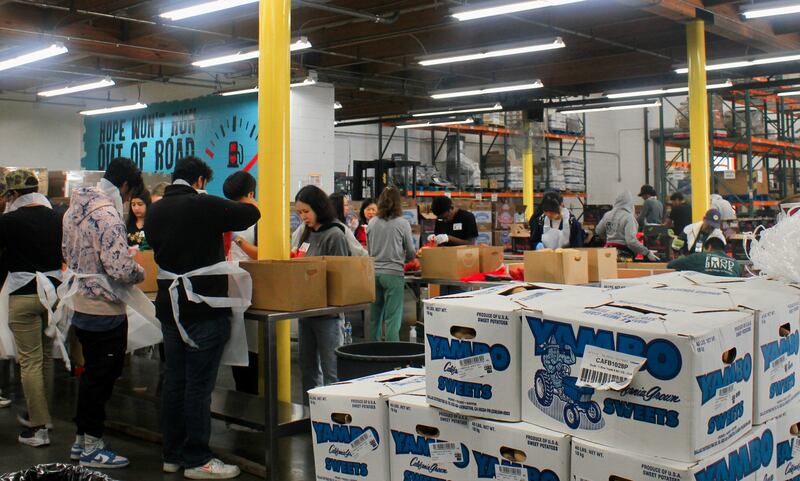 A photo of volunteers doing work at a food bank.
