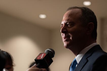 Photo of a reporter holding up microphone for the interviewee