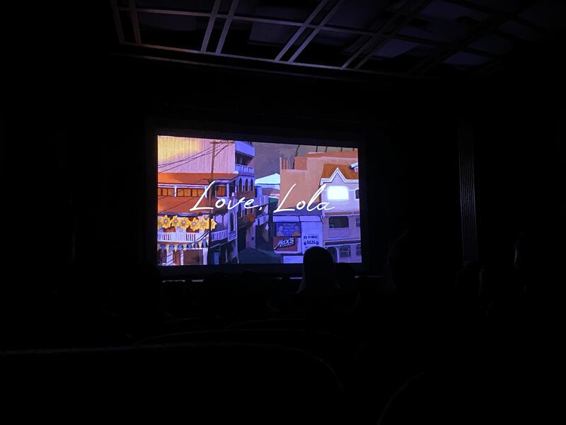 Love, Lola projected on a screen at a film festival