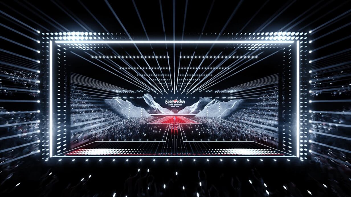 The stage is black with several lights and a red platform for the performance.
