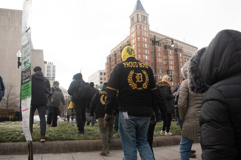 Two men with Proud Boys jackets walking.
