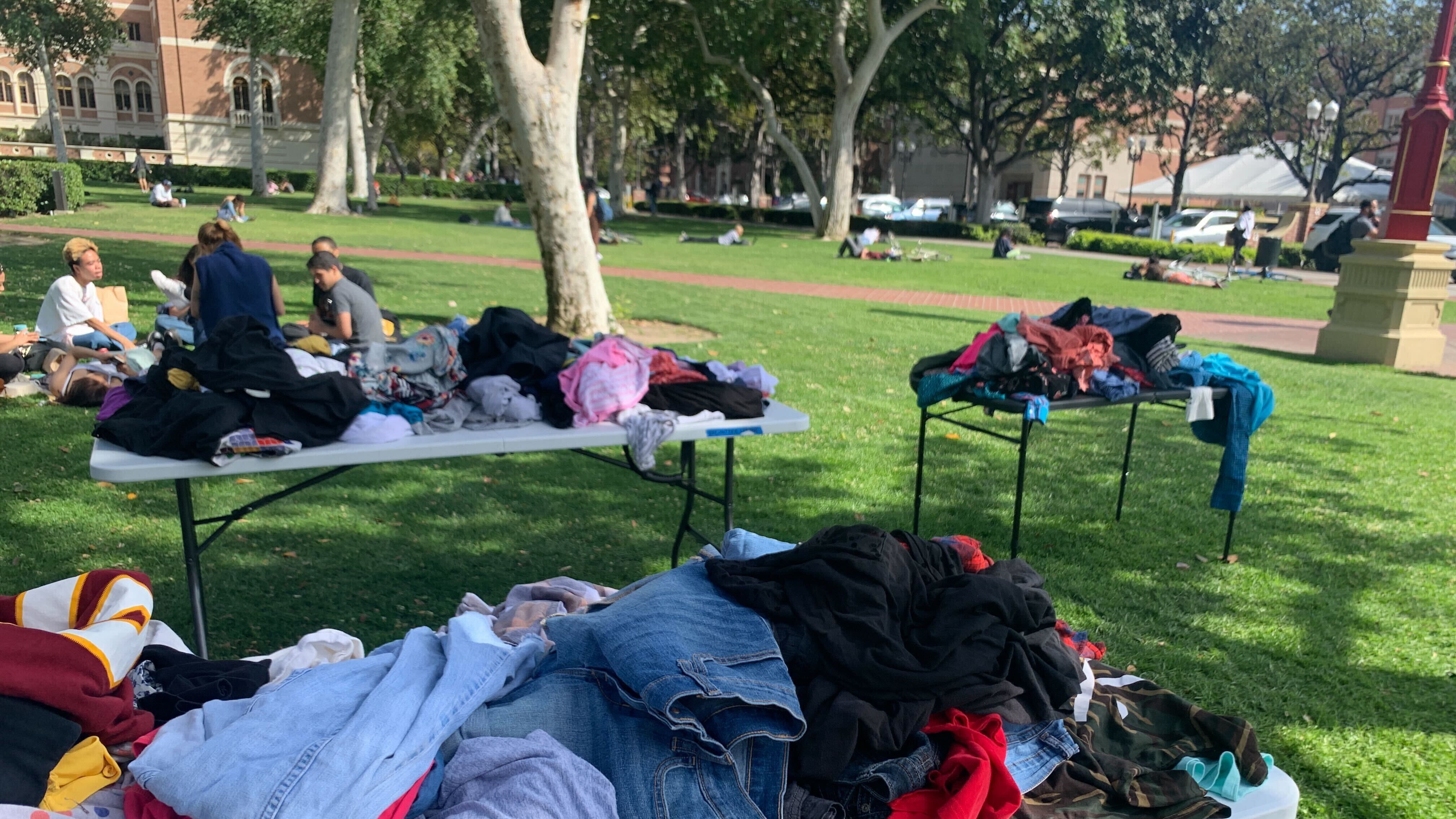 A photo of pants, dresses, shoes and athletic wear were spread out on tables, racks, and boxes for all students to grab.