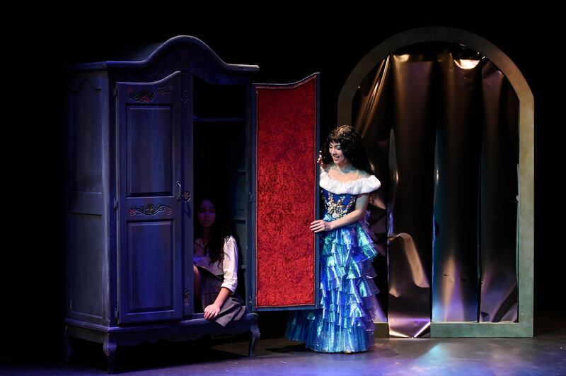 A photo of actors on a stage performing in a play.