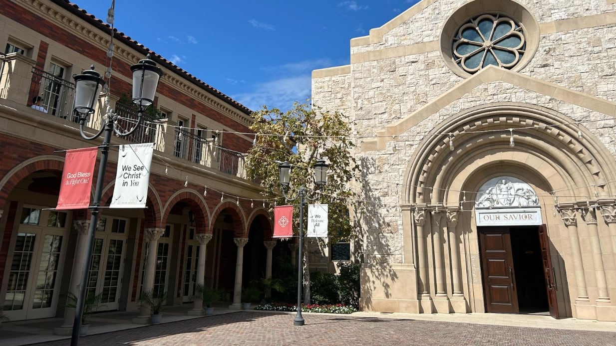 The church is made out of stone and reads "Our Savior" on the front door.