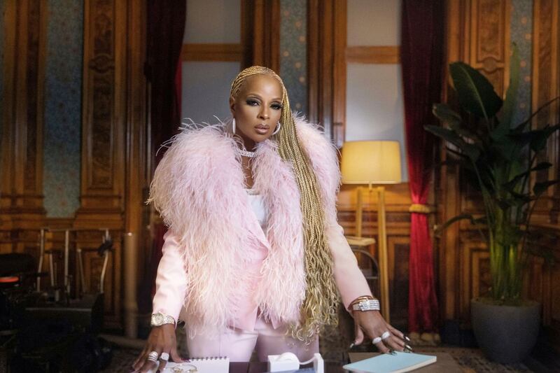 Mary J. Blige poses in a pink outfit.