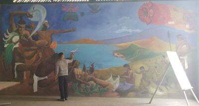 Photo of man and mural