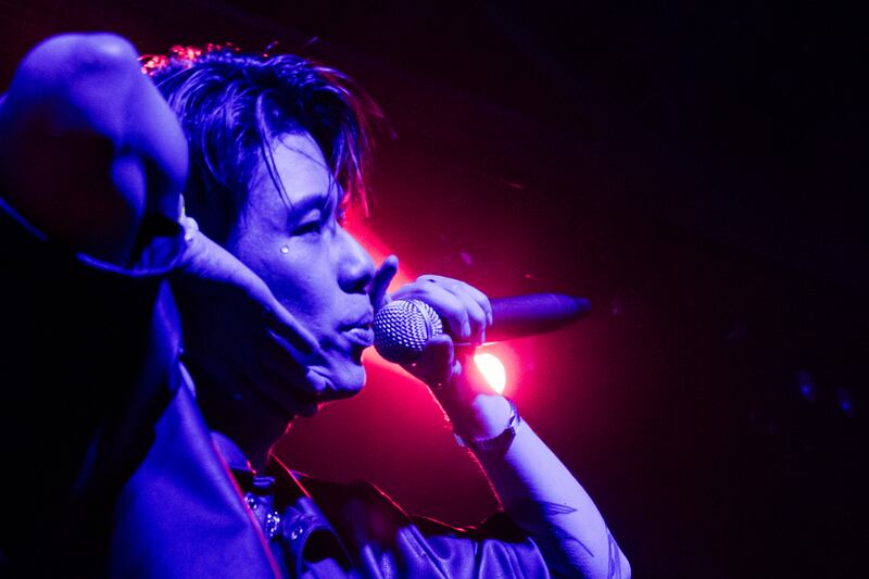 Photo of a man singing into a microphone