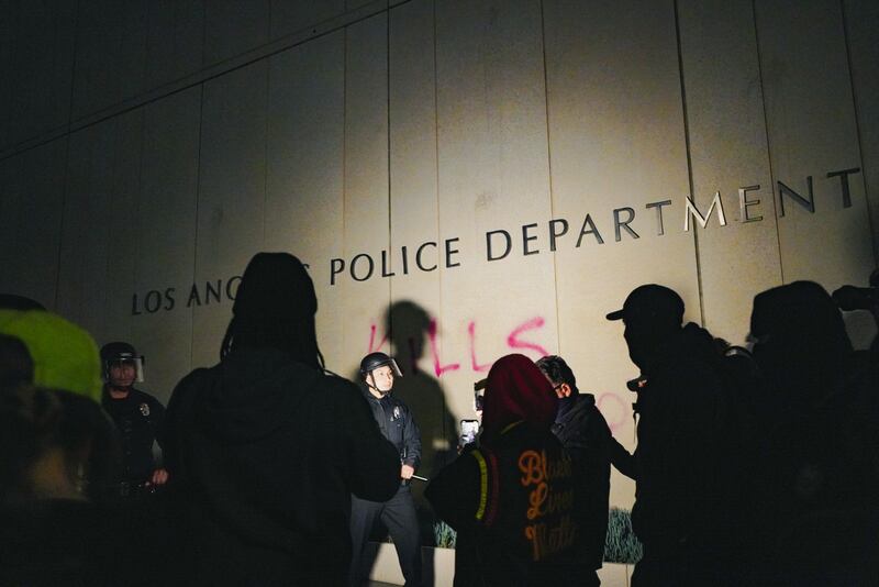 [Photo of graffiti reading "Los Angeles Police Department *Kills*" at LAPD HQ.]